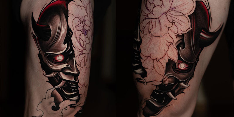 Japanese Oni demon mask tattoo on thigh with glowing red eye and peony flower outlines in realism style, by Rinat Mingazdinov, Los Angeles