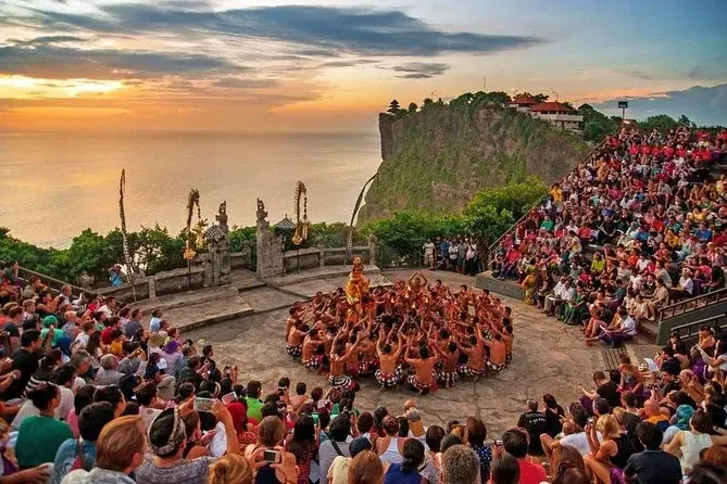 A large crowd watching the traditional Kecak fire dance at Pura Luhur Uluwatu during sunset, a must-see event for what happens in Bali on Wednesday.