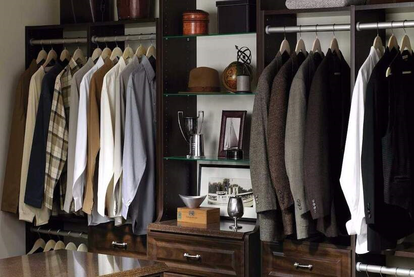 мужской гардероб с базовыми цветами одежды на вешалках