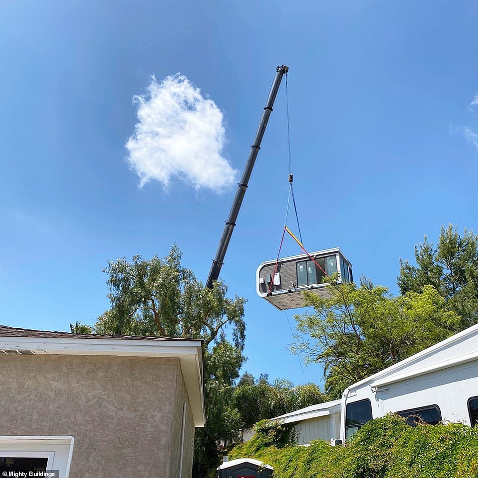 The unit is lifted into the customer's back garden using a crane, after being developed at Mighty Building facilities and transported on a truck