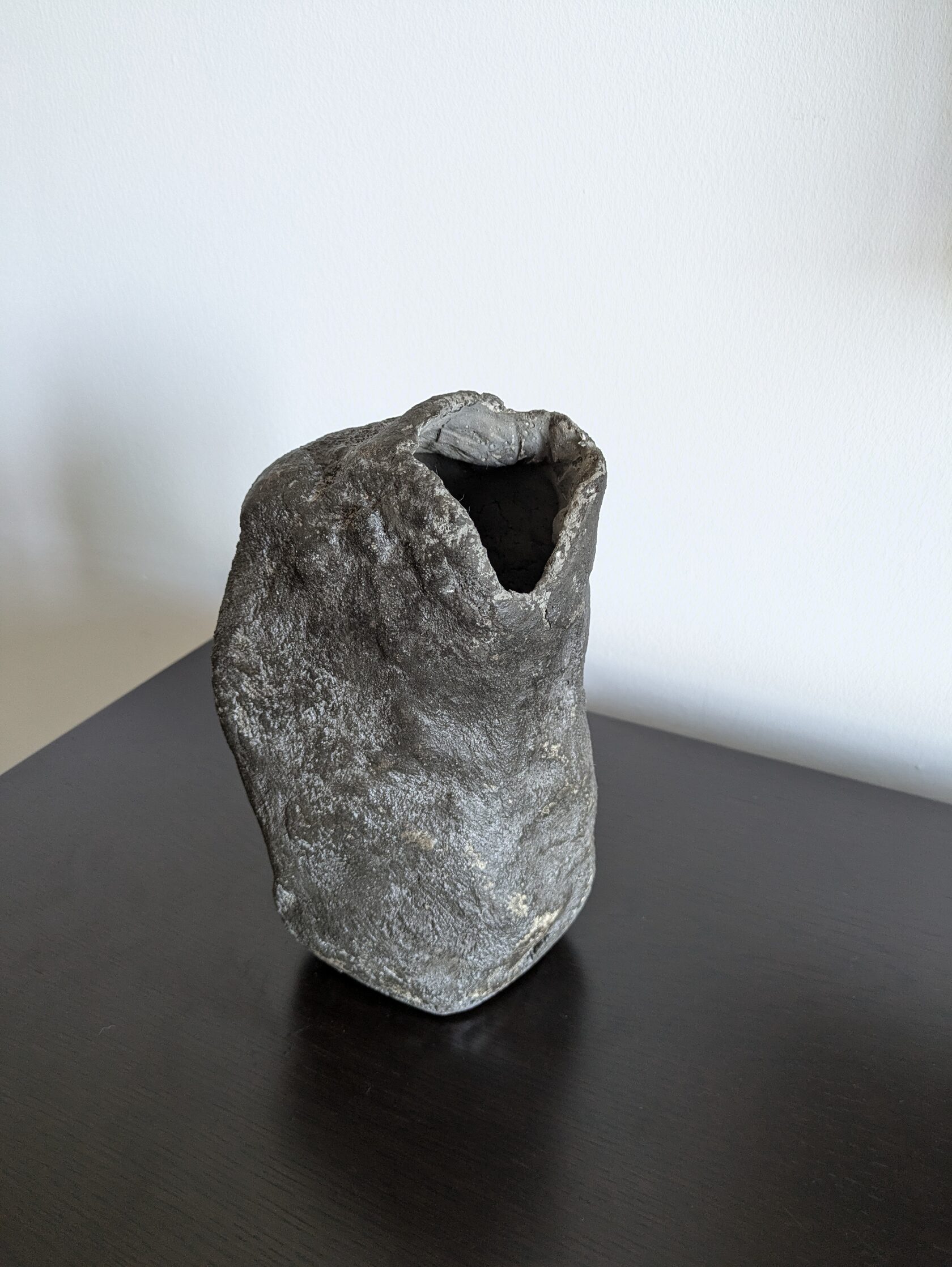 Concrete vase with bold, bright flowers