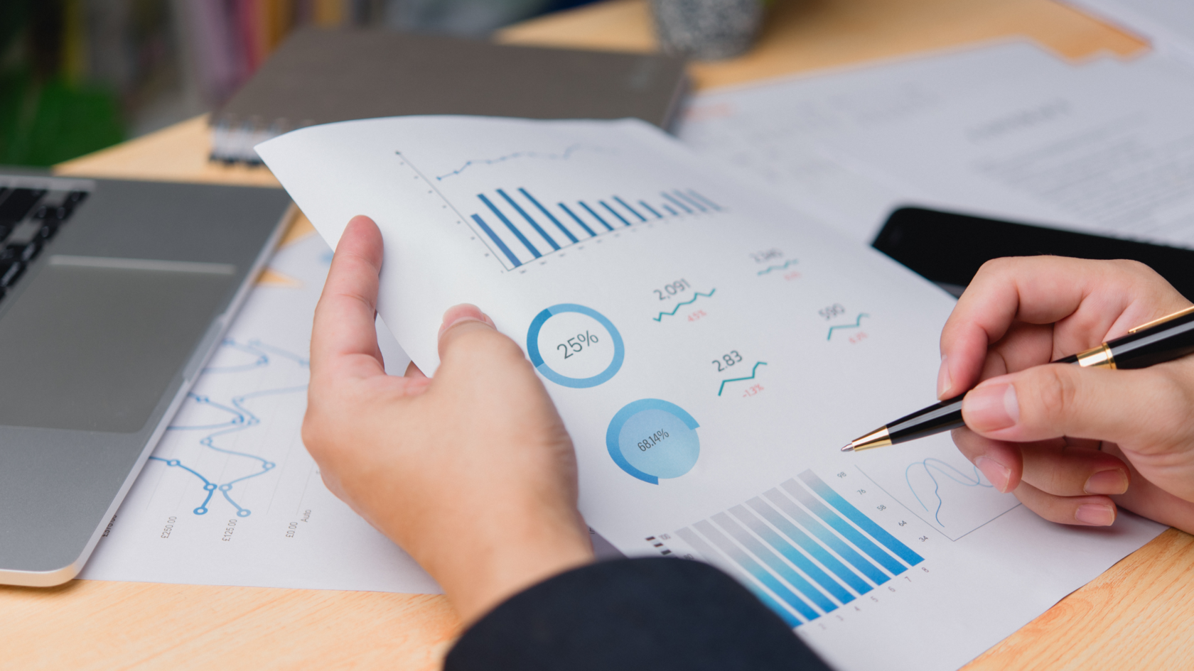 A person looking at papers indicating a review of their financial operations.