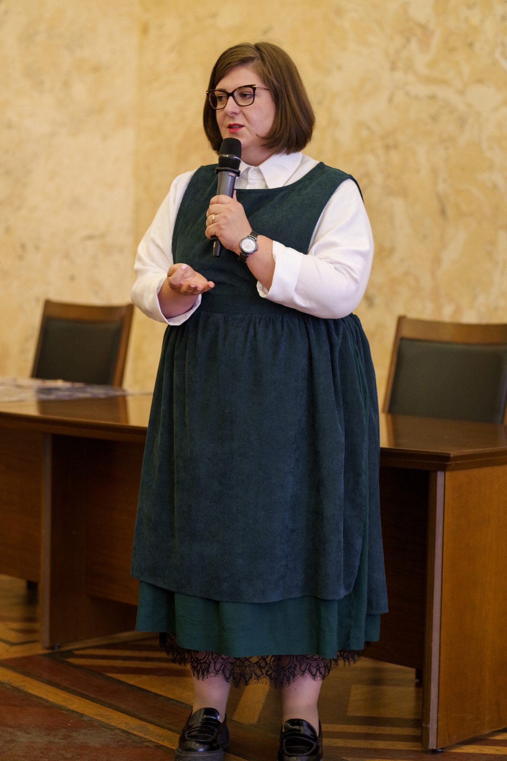 Kristina speaking at a professional event