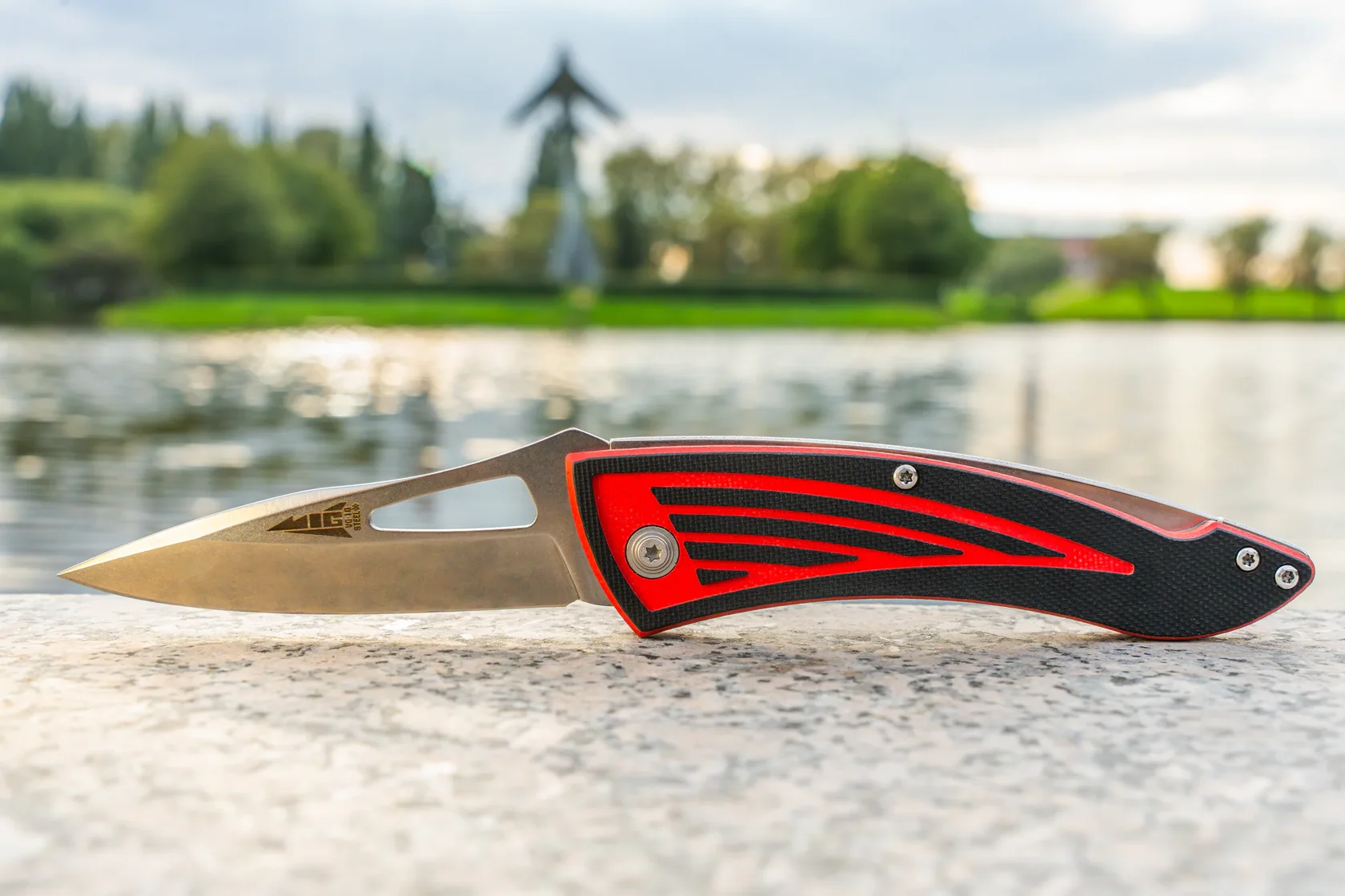 MiG open blade and two-tone G10 handle photographed outdoors