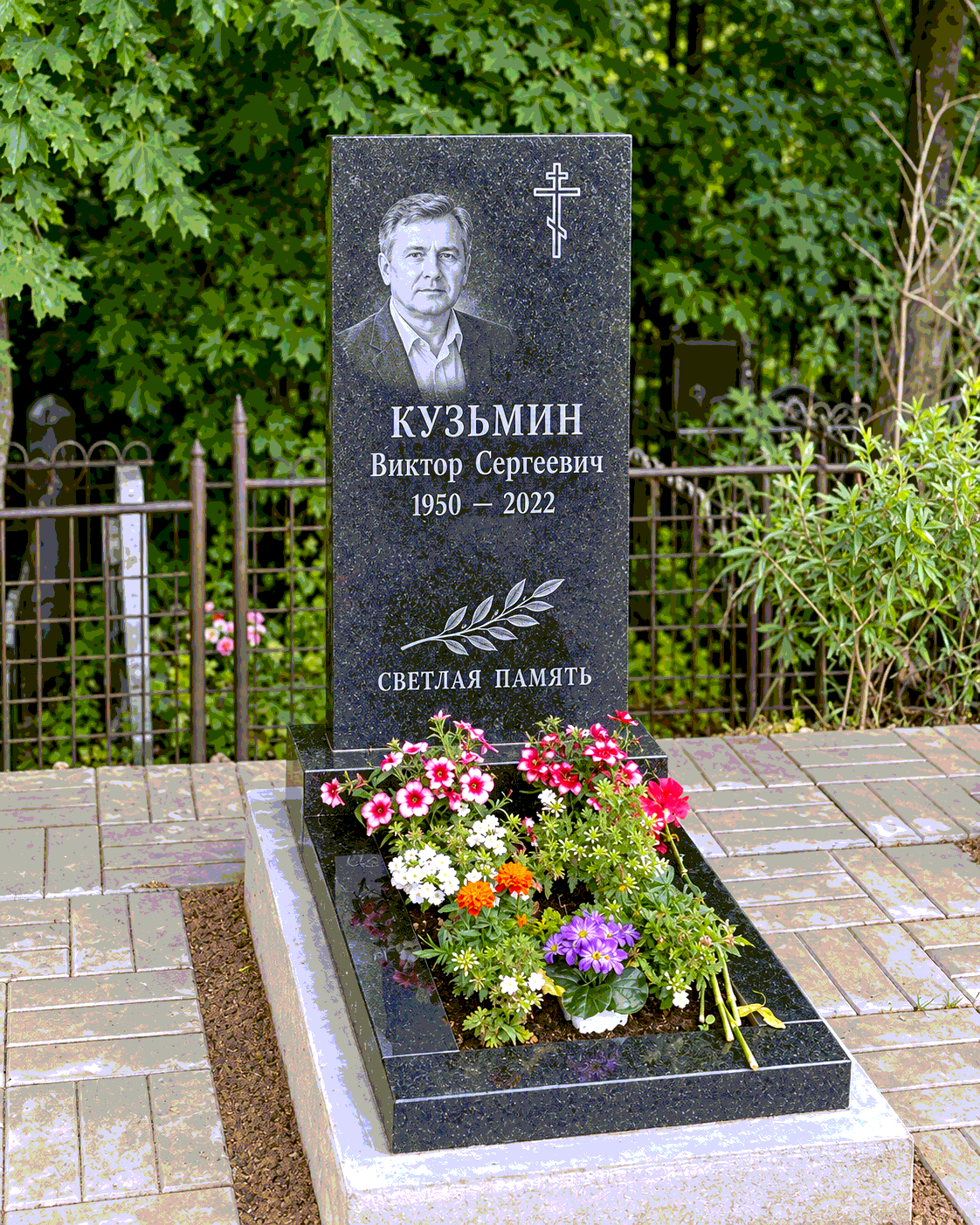 Прямой памятник с цветником после установки на участке. Имена, даты и портреты изменены.