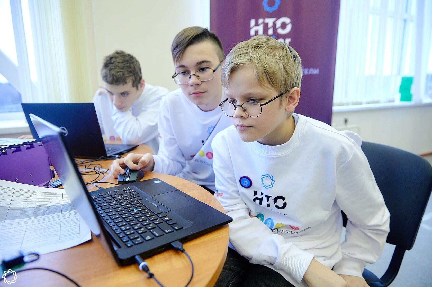 Участники НТО Junior смотрят в монитор ноутбука