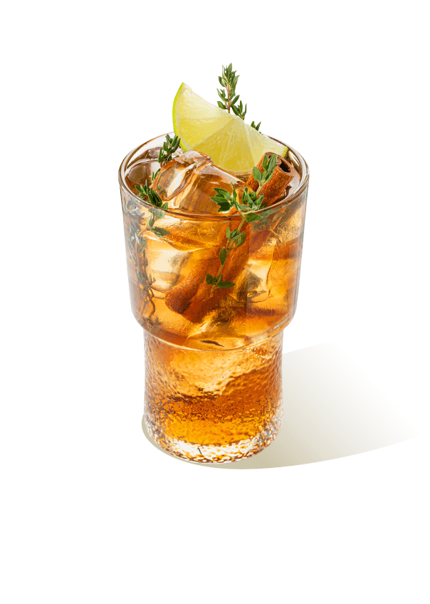 Cordial-based iced drink with lime, thyme, and cinnamon sticks, made using The Base Beverage flavored powder for horeca and mixology