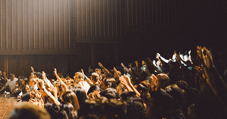 зрители тянут руки к сцене