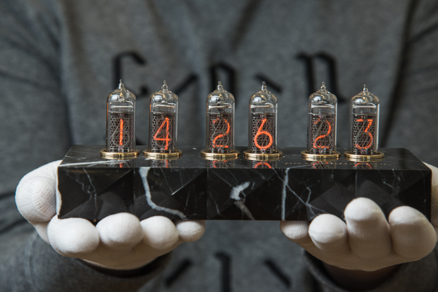 Nixie tube clock with Soviet nixie tubes on a black marble clock case
