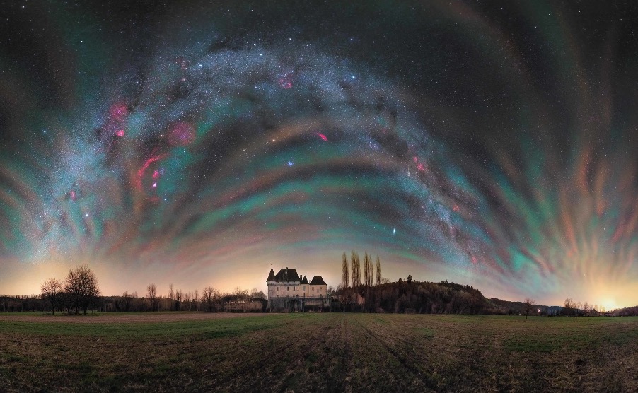 A house in a field with a starry skyDescription automatically generated