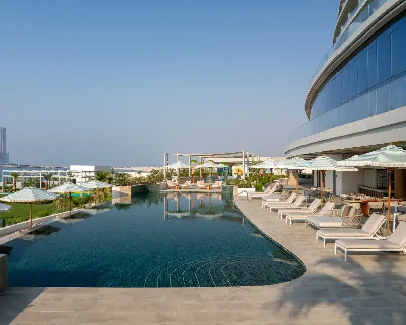 SO Ras Al Khaimah – это свежий ультра all inclusive на острове Аль-Марджан, открытый в ноябре 2025, где модный дизайн встречает море с 257 номерами и сюитами с видами на Аравийский залив. Частный пляж, infinity-бассейны, спа-клуб 650 кв.м и спорт-зона с классами – все включено для активного отдыха в ОАЭ летом. Стилисты интерьеры с искусством от Curio, 13 ресторанов и баров, плюс ивенты до 300 человек делают его хабом для шопинга без очередей и релакса. Всего 90 минут от Дубая, но здесь тишина и волны. 