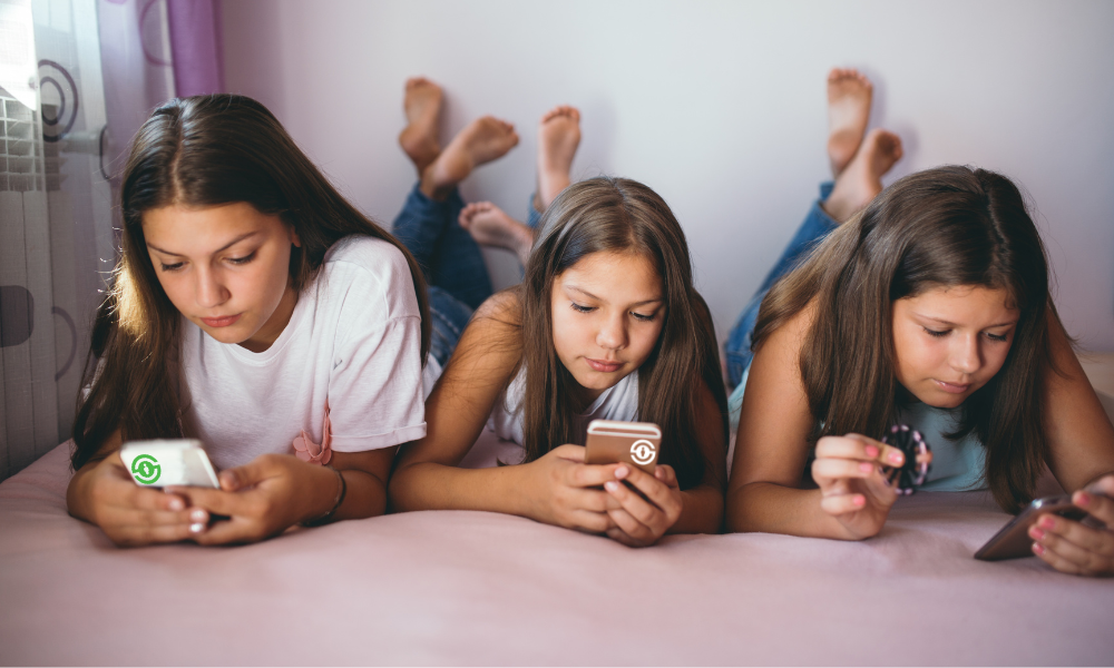 3 children on their phones looking intently at the content