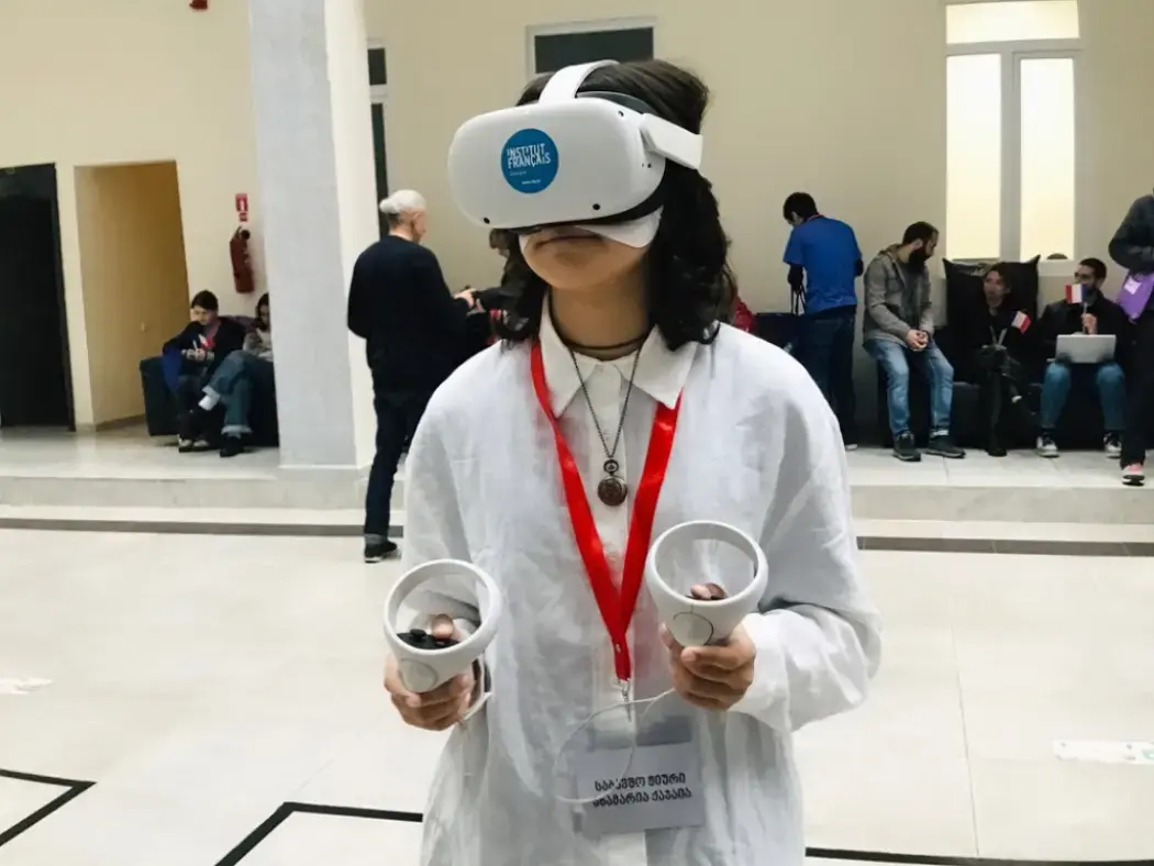 Young visitor using a VR headset and controllers
