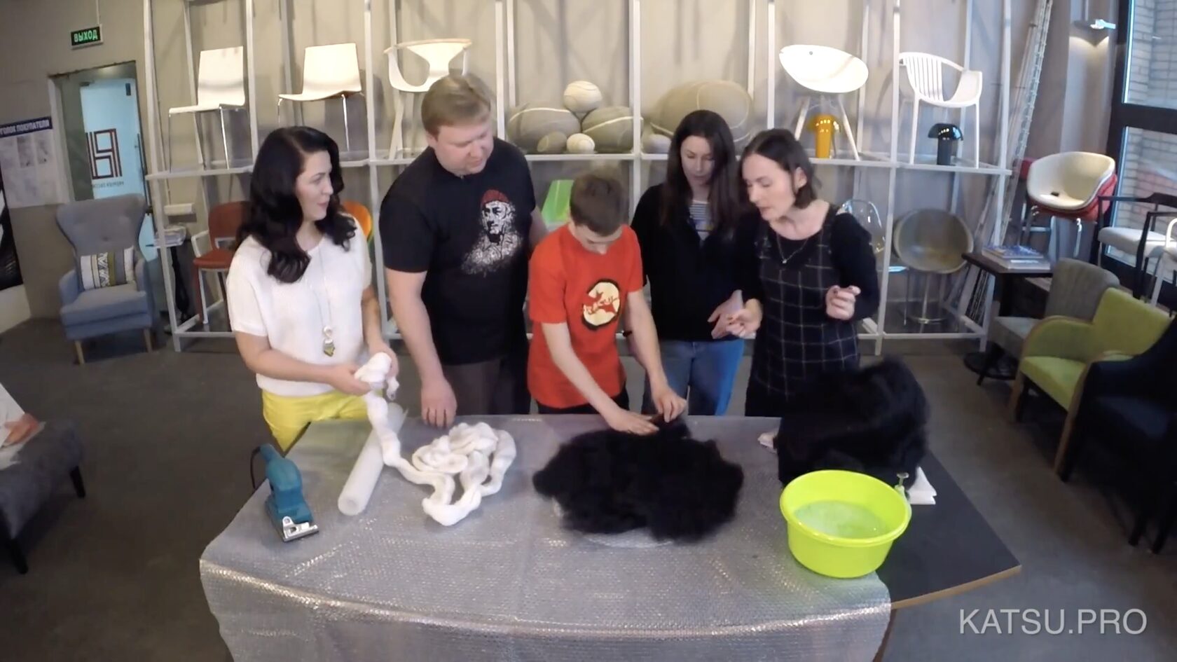 A group of people make a felted wool stone pillow in a TV show