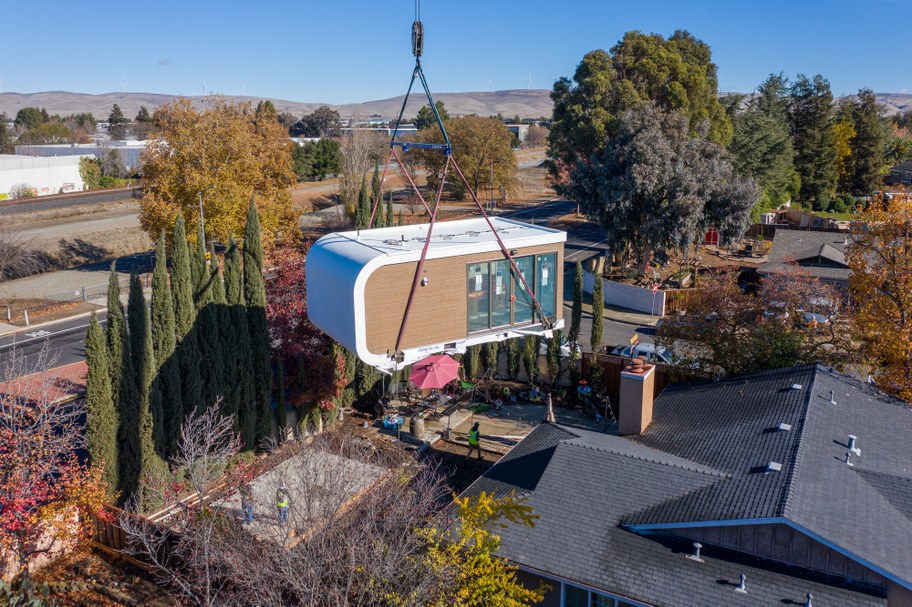 A crane dropping Mighty Buildings' 350 square foot studio model into a backyard in Livermore, CA. Photo courtesy of Mighty Buildings.