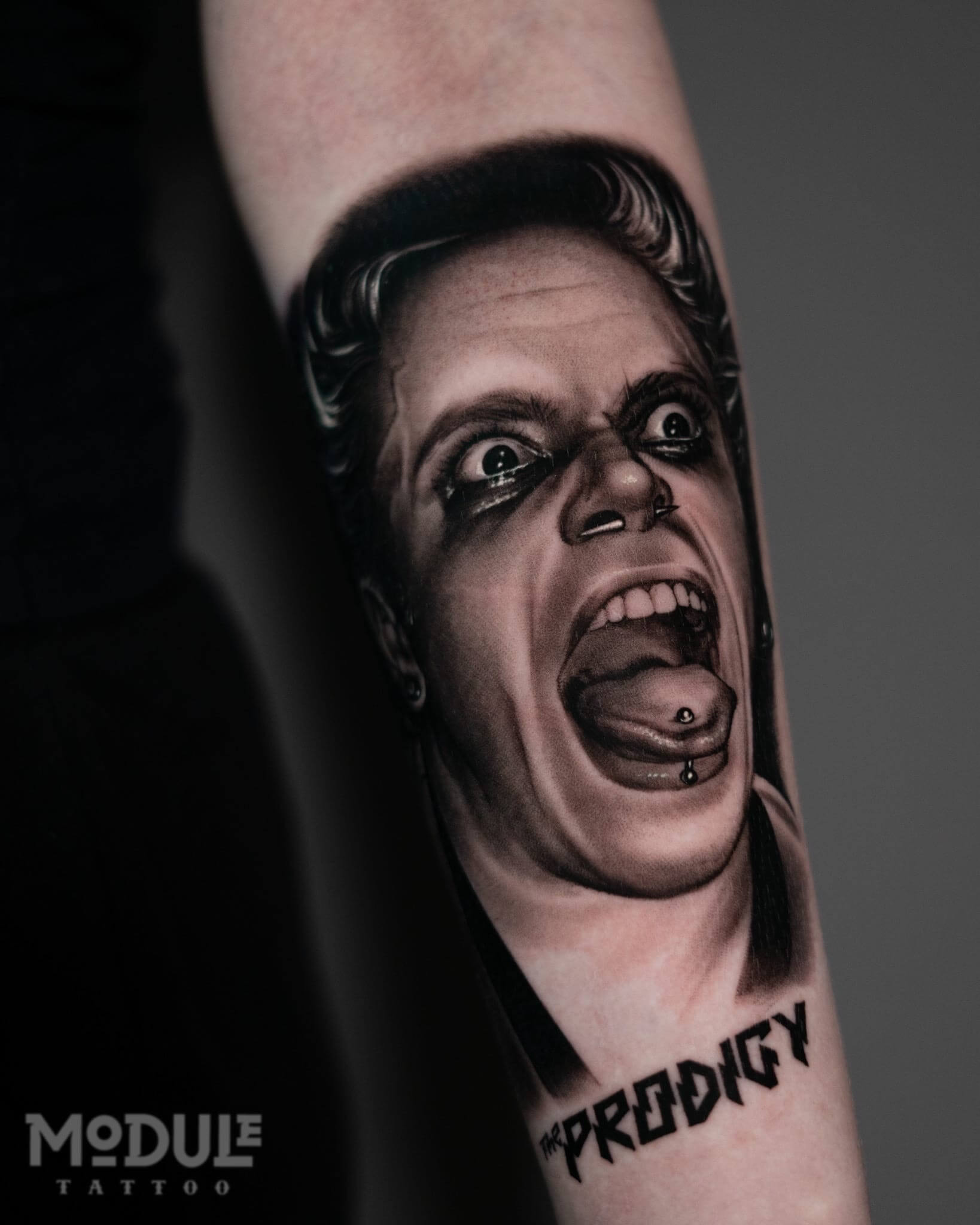 Tattoo on the shoulder, black and white realistic portrait of the vocalist of the band Prodigy, Flint, Los Angeles