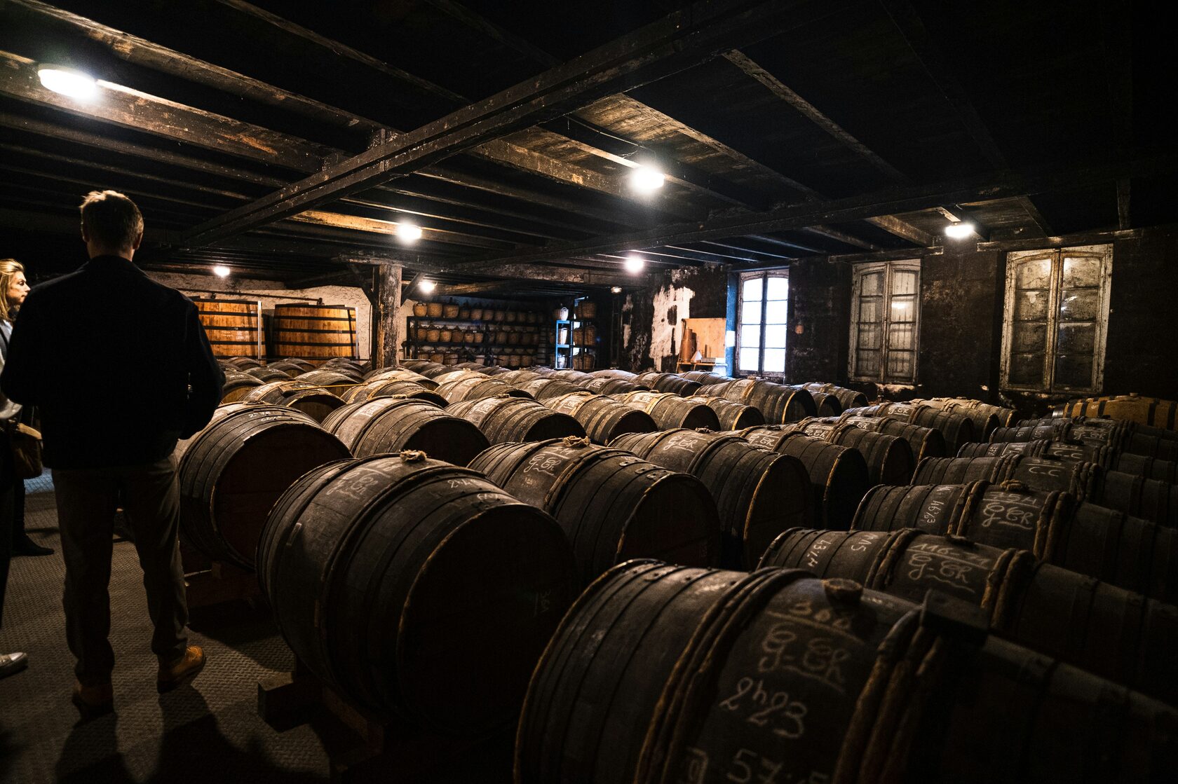 Winery owner leading cellar tour for guests