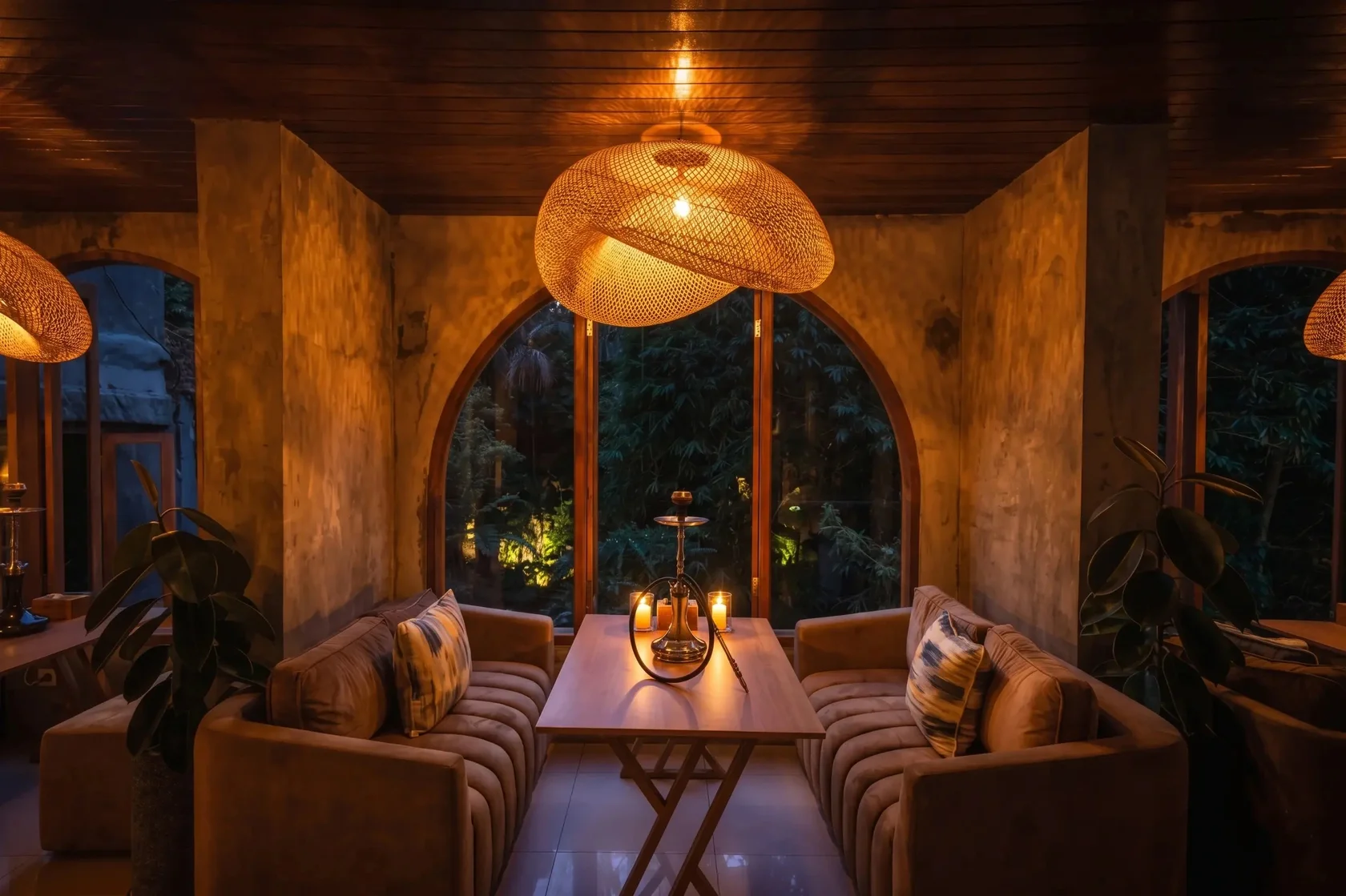 A cozy and relaxing lounge area with a shisha pipe and beautiful forest views, perfect for enjoying the best pizza in Ubud.
