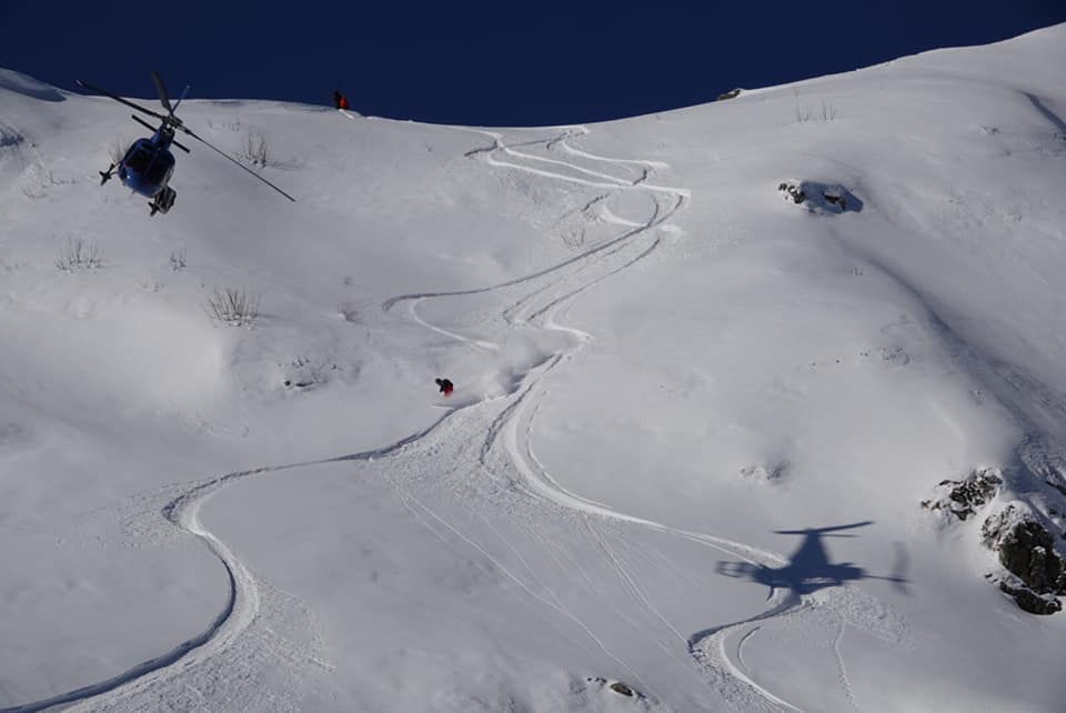 Heliskiing in Krasnaya Polyana, an AS350 B3 helicopter over the ridge