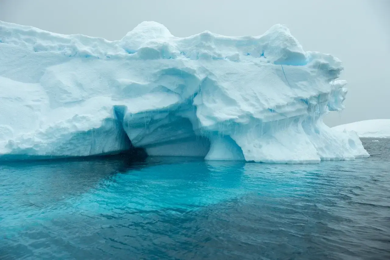 antarctic blue waters with iceberg