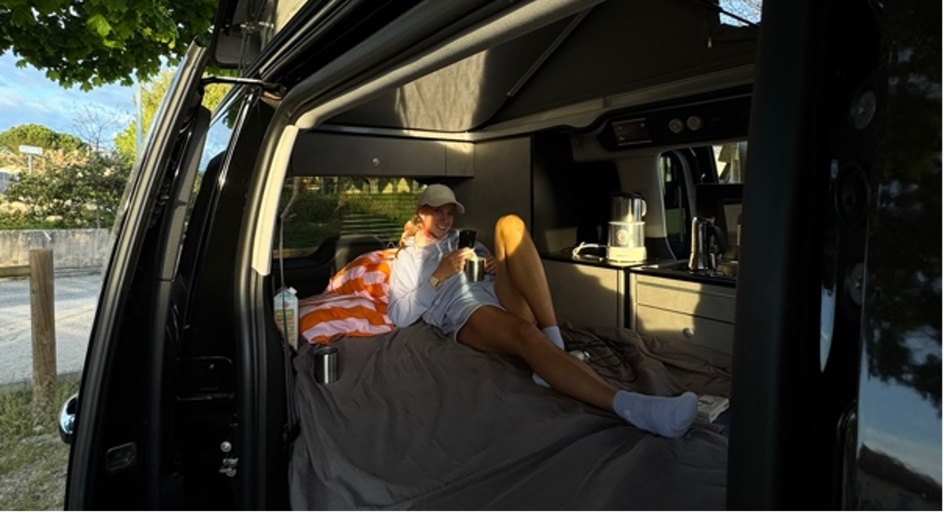 A person lying in a van
AI-generated content may be incorrect.