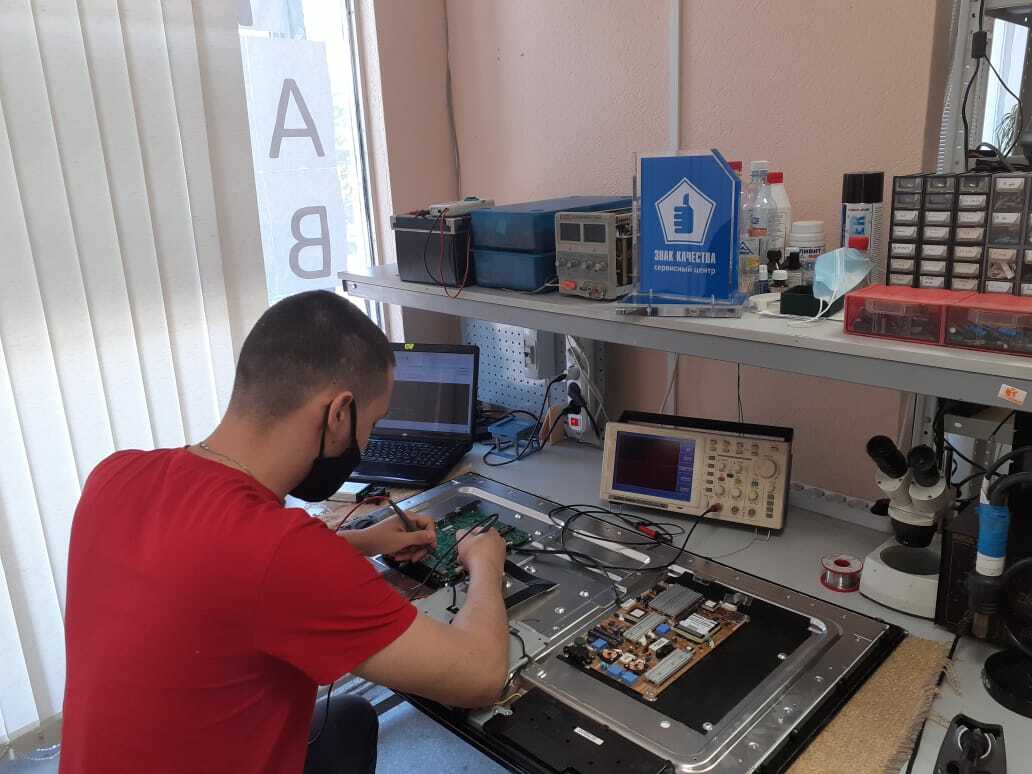 Специалист ремонтирует телевизор в филиале не Бардина