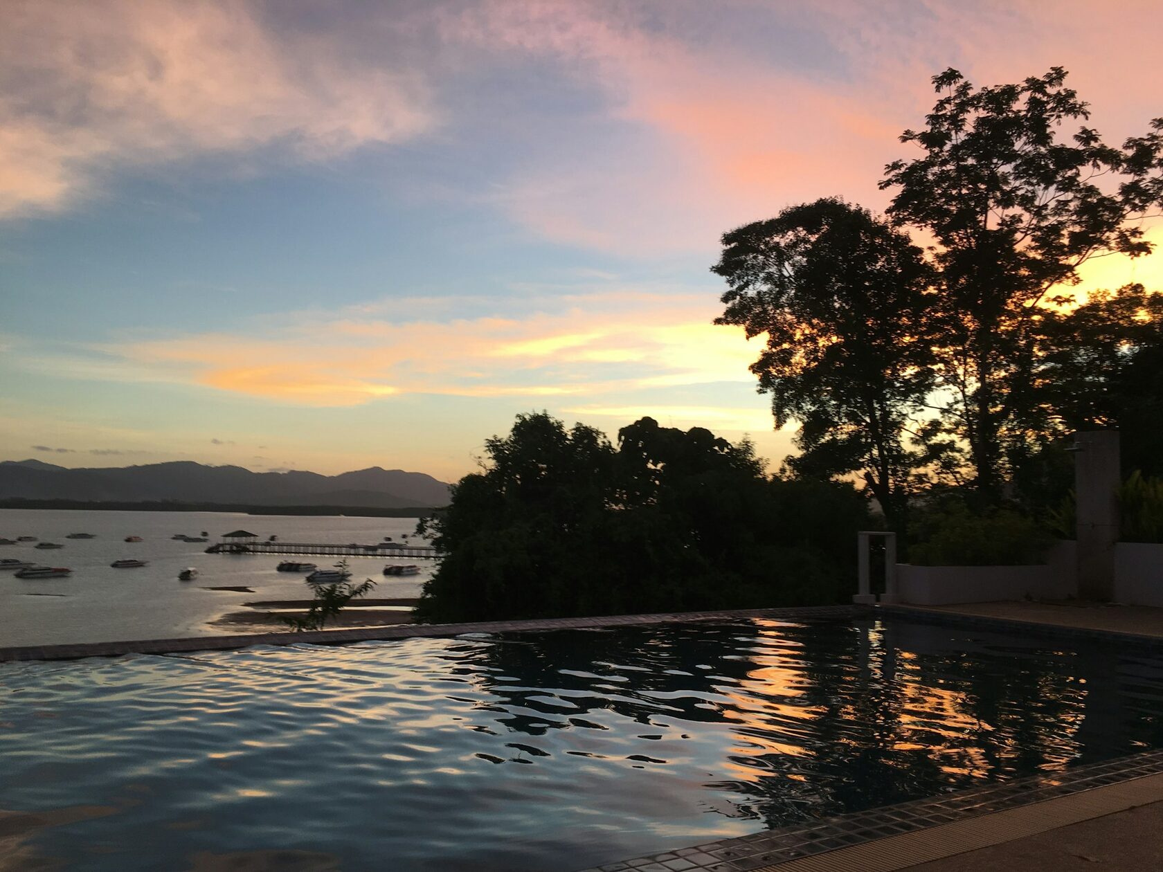Beach club poolside at dusk with warm ambient lighting