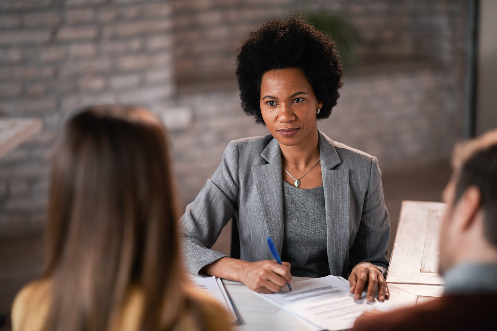 A professional domestic violence lawyer consulting with a female victim in a private office setting, providing legal guidance and support.