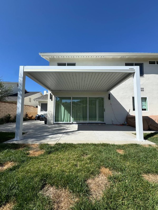 Motorized louvered patio cover closed over Huntington Beach backyard