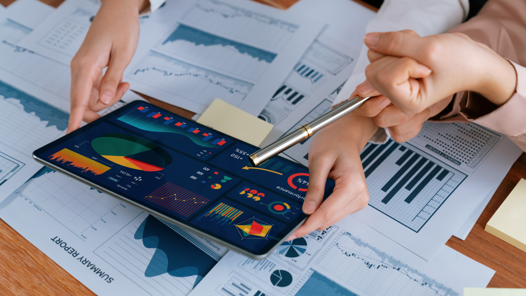 Two professionals working together on a growth strategy based on financial reports.