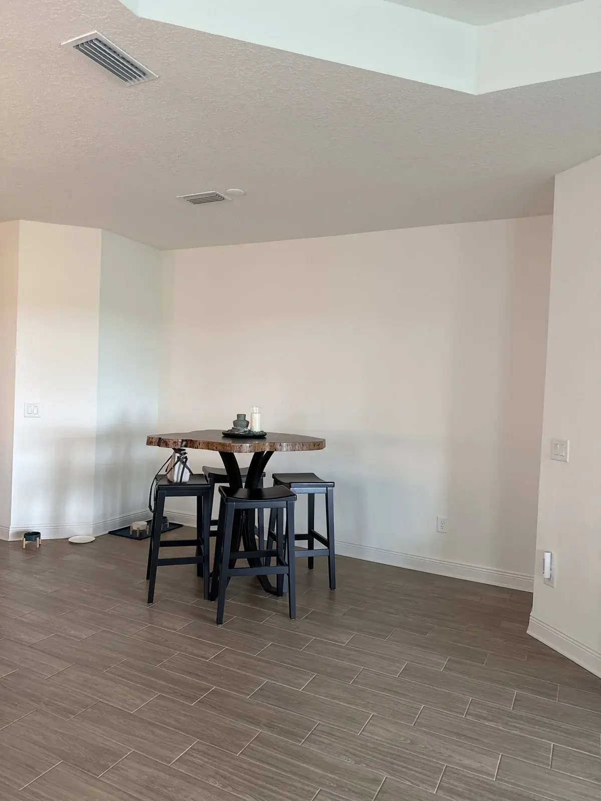 Plain dining area wall before board and batten accent wall installation in Bradenton.