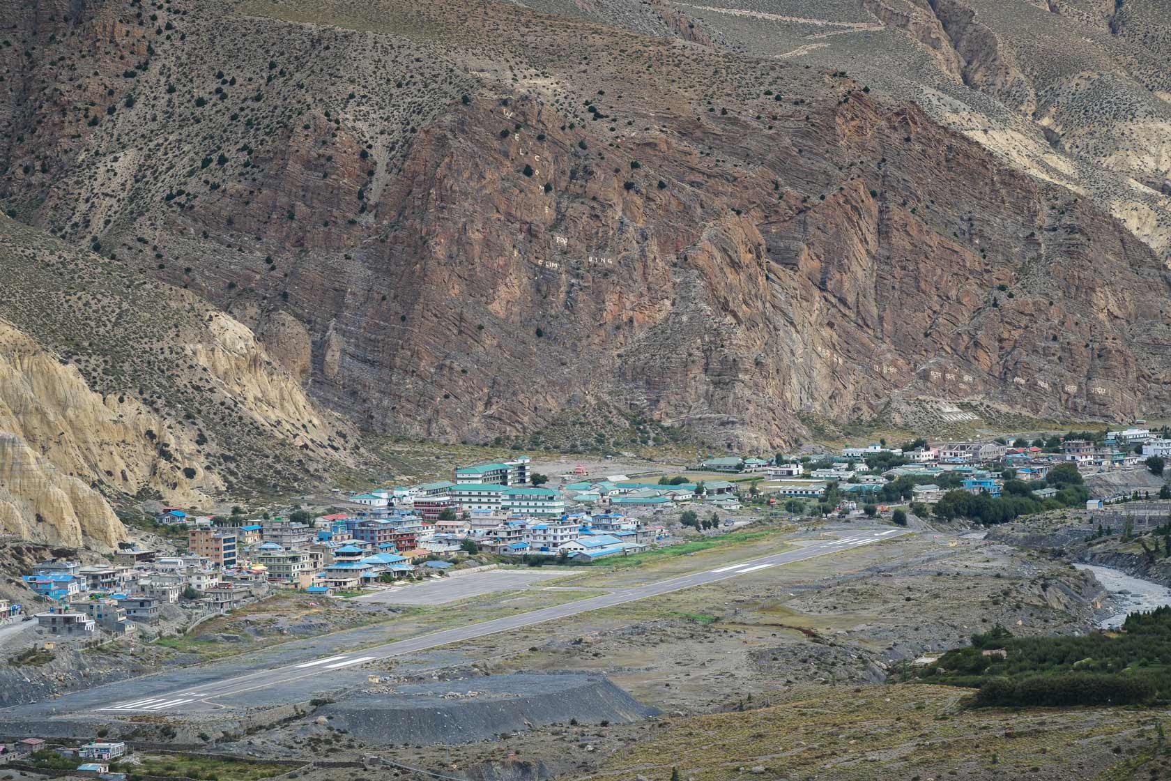 Аэропорт Джомсома в долине Кали-Гандаки: взлетно-посадочная полоса и город на фоне гор Мустанга
