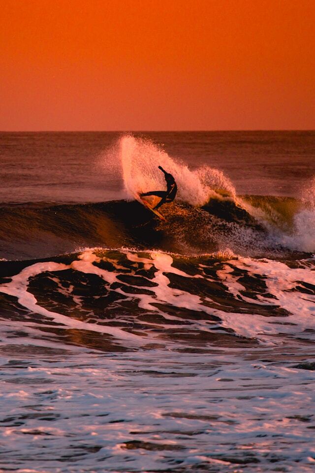 Surfer riding reef break waves at Playgrounds surf spot in Nusa Lembongan