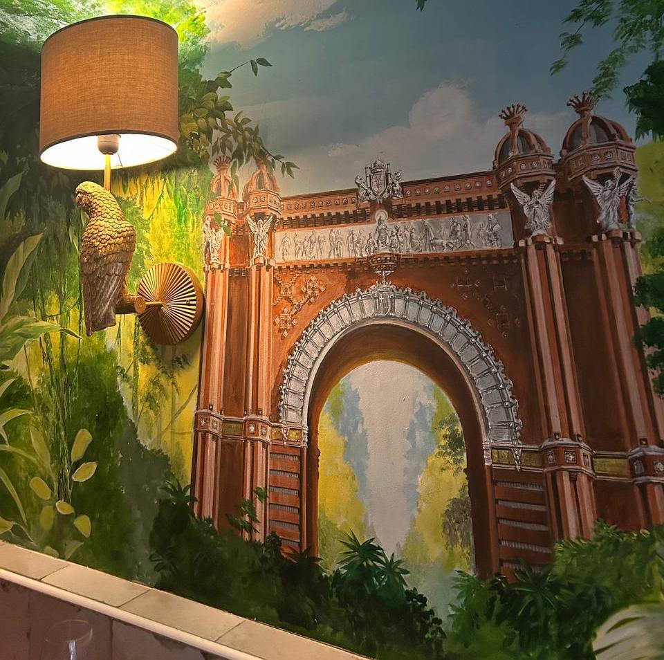 Sensi Tapas vaulted brick dining room with green jungle mural and the Arc de Triomf painted in
