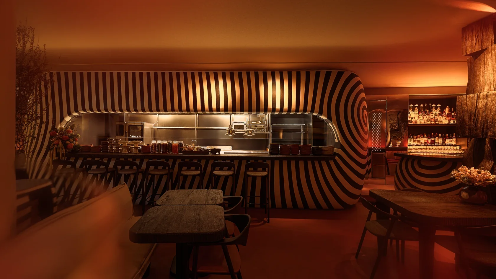 Wide view of the Sobremesa dining room and its sculptural striped bar
