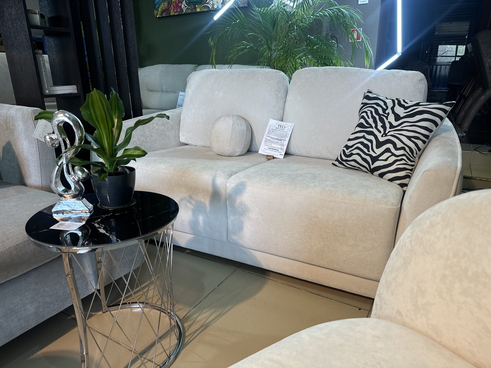 Sofa with elephant decor and palm pillow