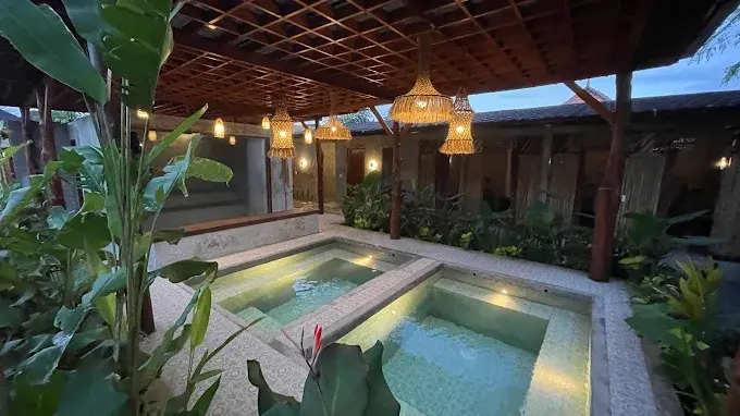 Beautifully designed hot and cold plunge pools surrounded by tropical plants at Hesa Wellness Spa, offering deep recovery and standing out as a unique best spa in Ubud.