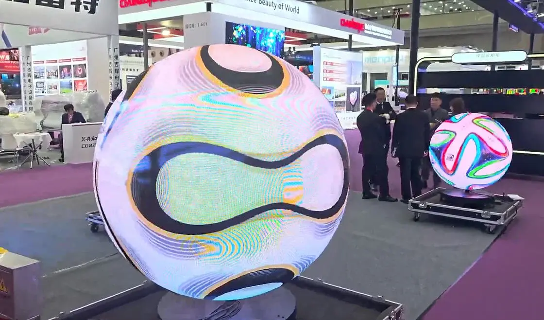 This may contain: a large blue screen is in the middle of a building with people standing around it