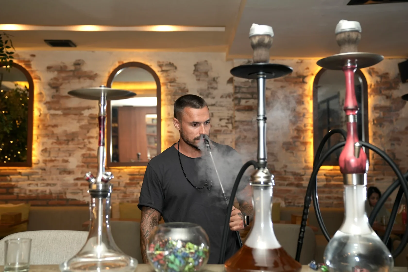 A guest enjoying a premium shisha session at Eden Hookah Club the perfect lounge to explore top-tier Adalya alternatives in Bali.