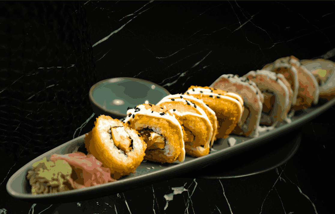 A serving of crispy tempura sushi rolls, adding a crunchy Asian twist to the halal food in Ubud scene at Eden Lounge.