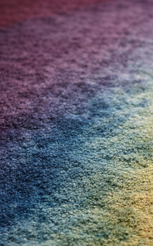 Ombre dyed rug in purple and blue tones