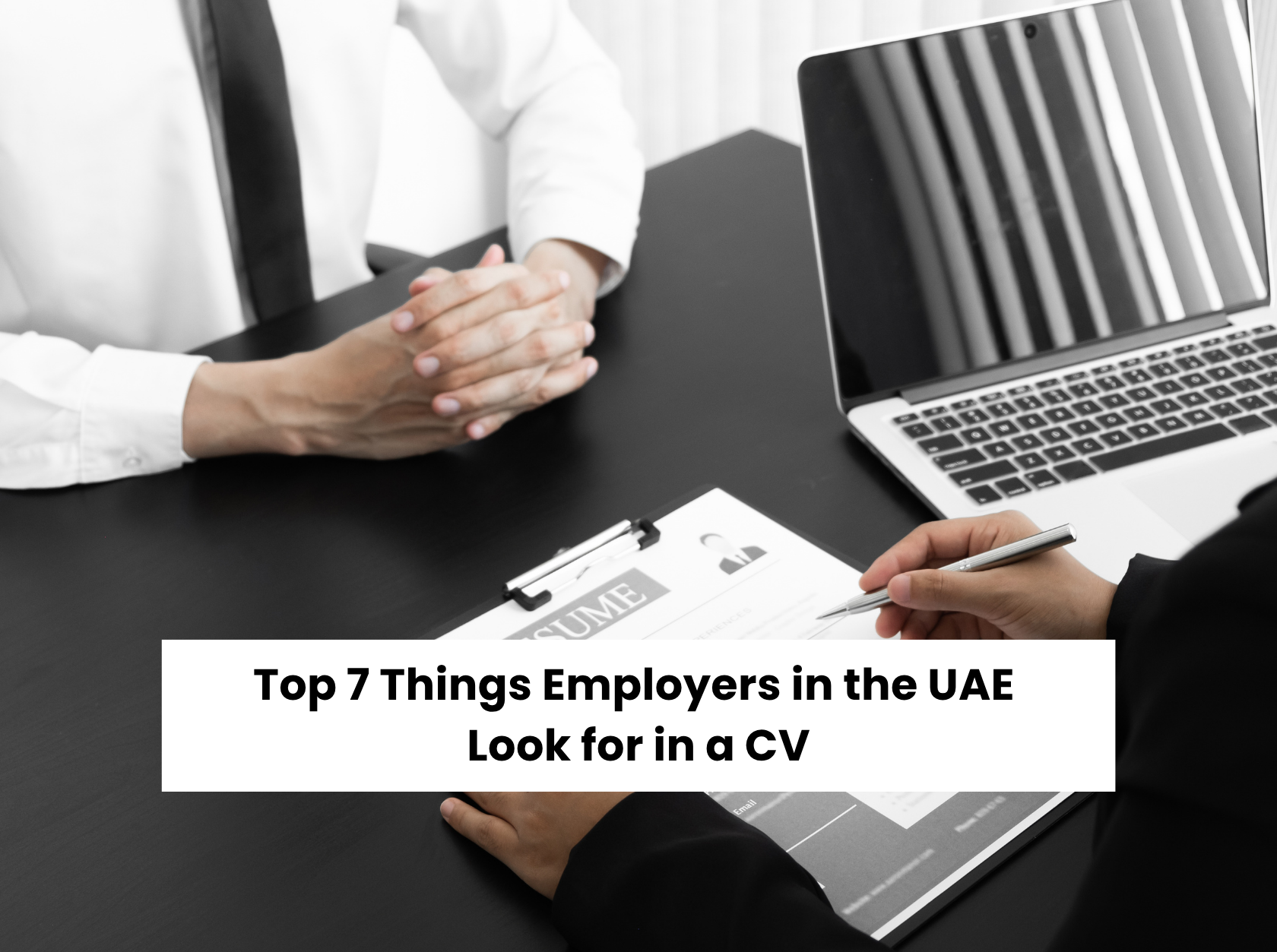 Two professionals reviewing a CV during a job discussion – understanding what UAE employers look for in a resume