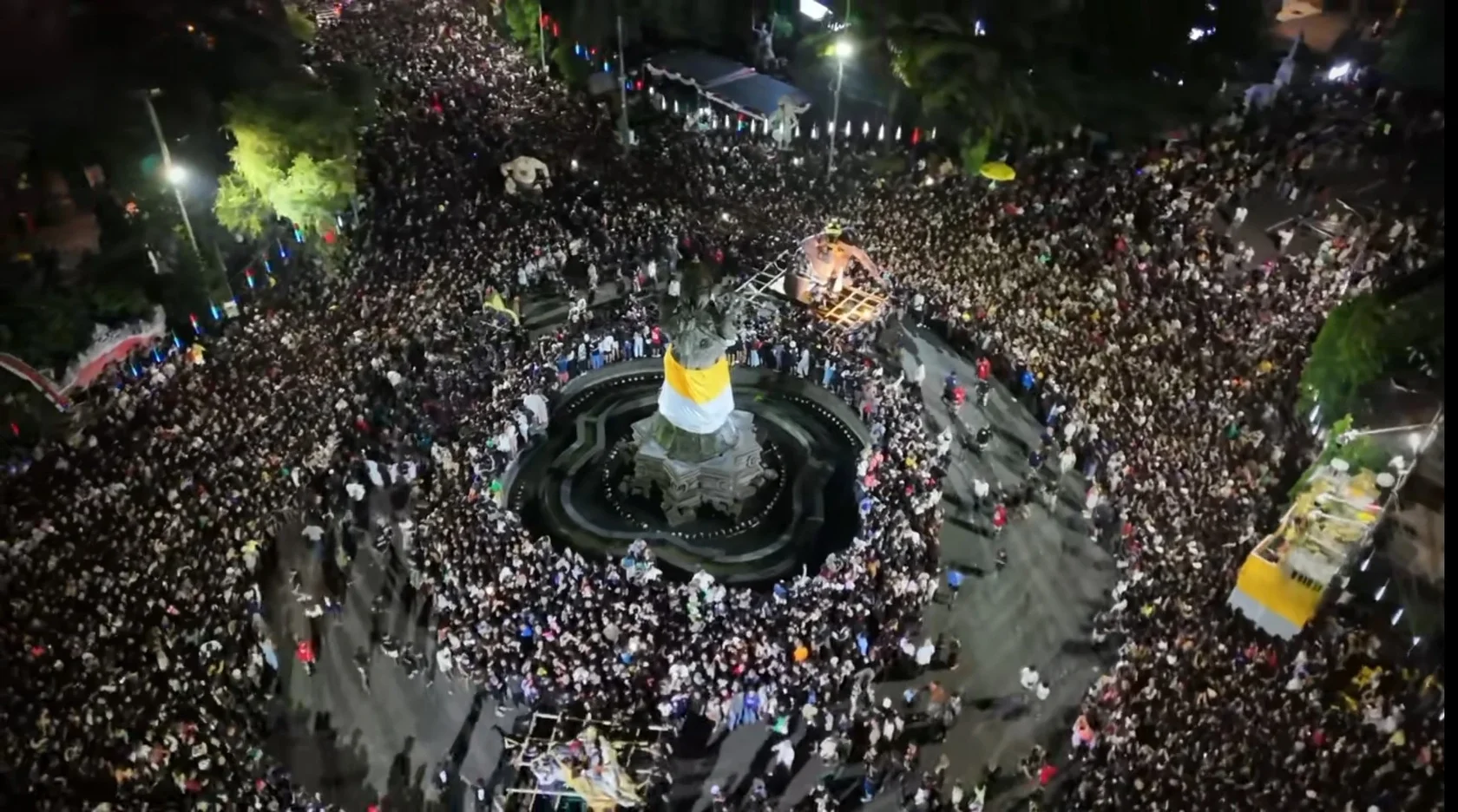 An aerial night view of the massive crowd gathered at Catur Muka Statue in Denpasar to celebrate the Pengerupukan eve of Nyepi.