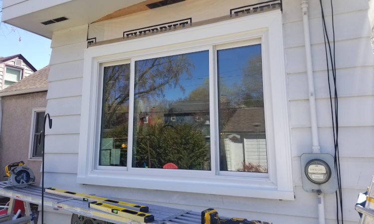 Window replacement in Seattle - professional installation of new vinyl windows on residential home