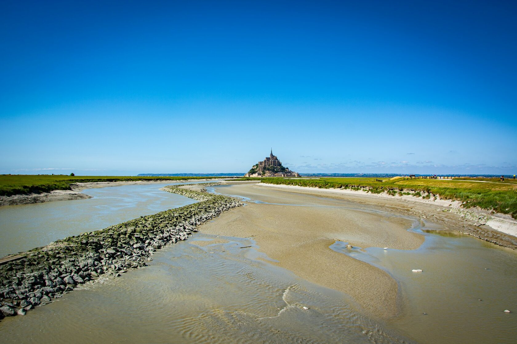 D-Day landing beach in Normandy with wide sandy shore and gentle waves