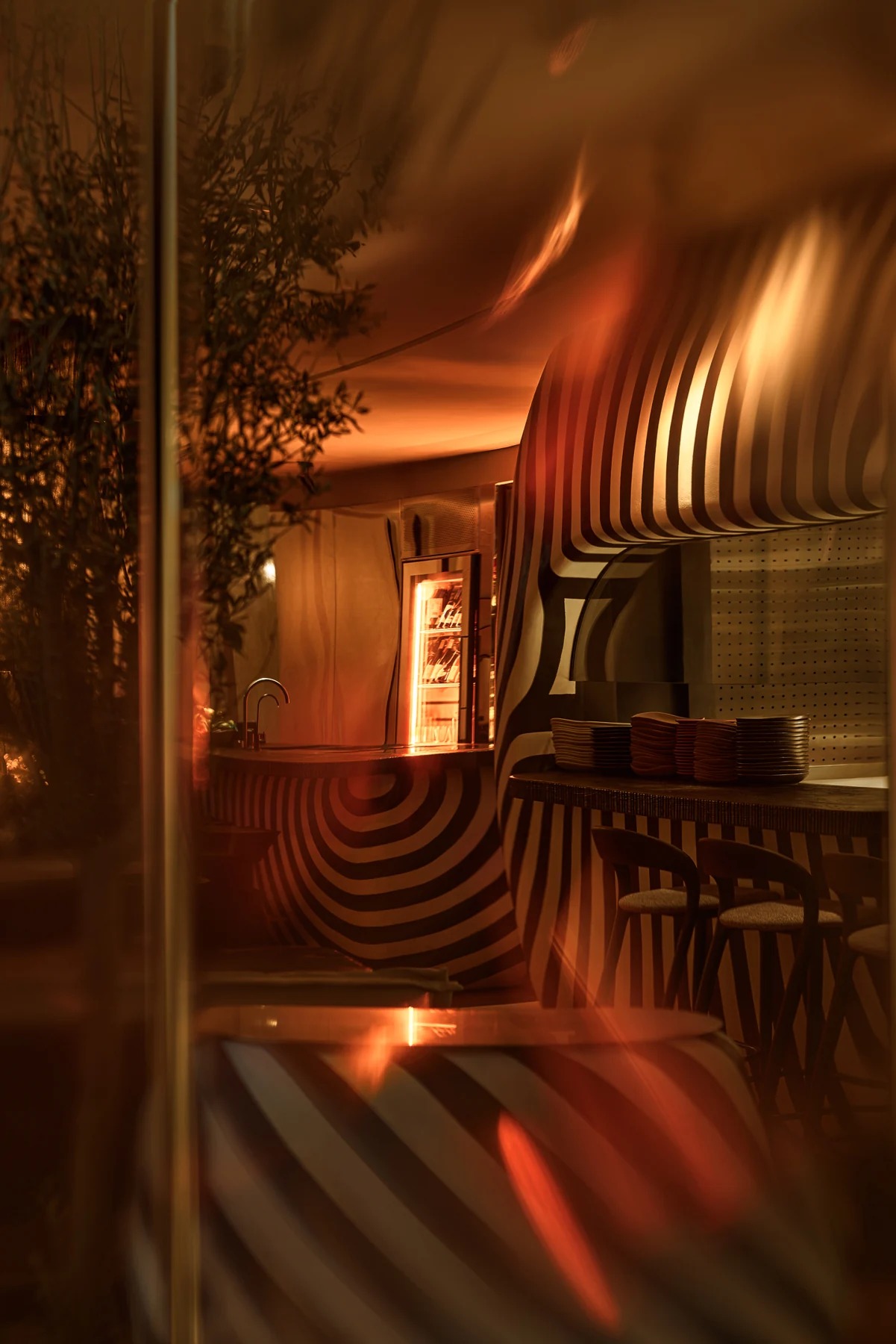 Warm lighting and striped bar at Sobremesa