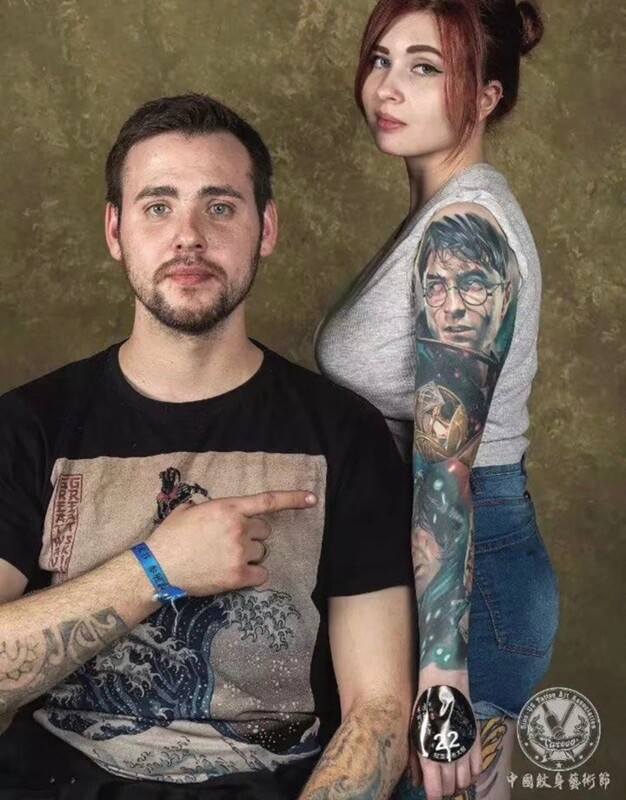 Andrey Kolbasin with his model showcasing a full-color Harry Potter realism sleeve tattoo 611