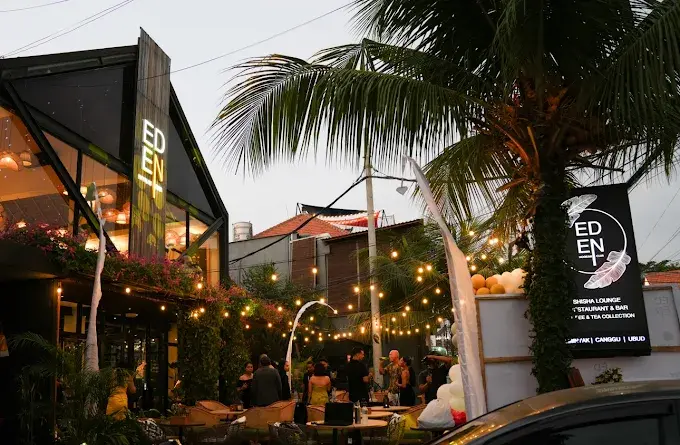 The welcoming and beautifully lit exterior of Eden Hookah Club at dusk, the perfect home base to start your pre party in Canggu.