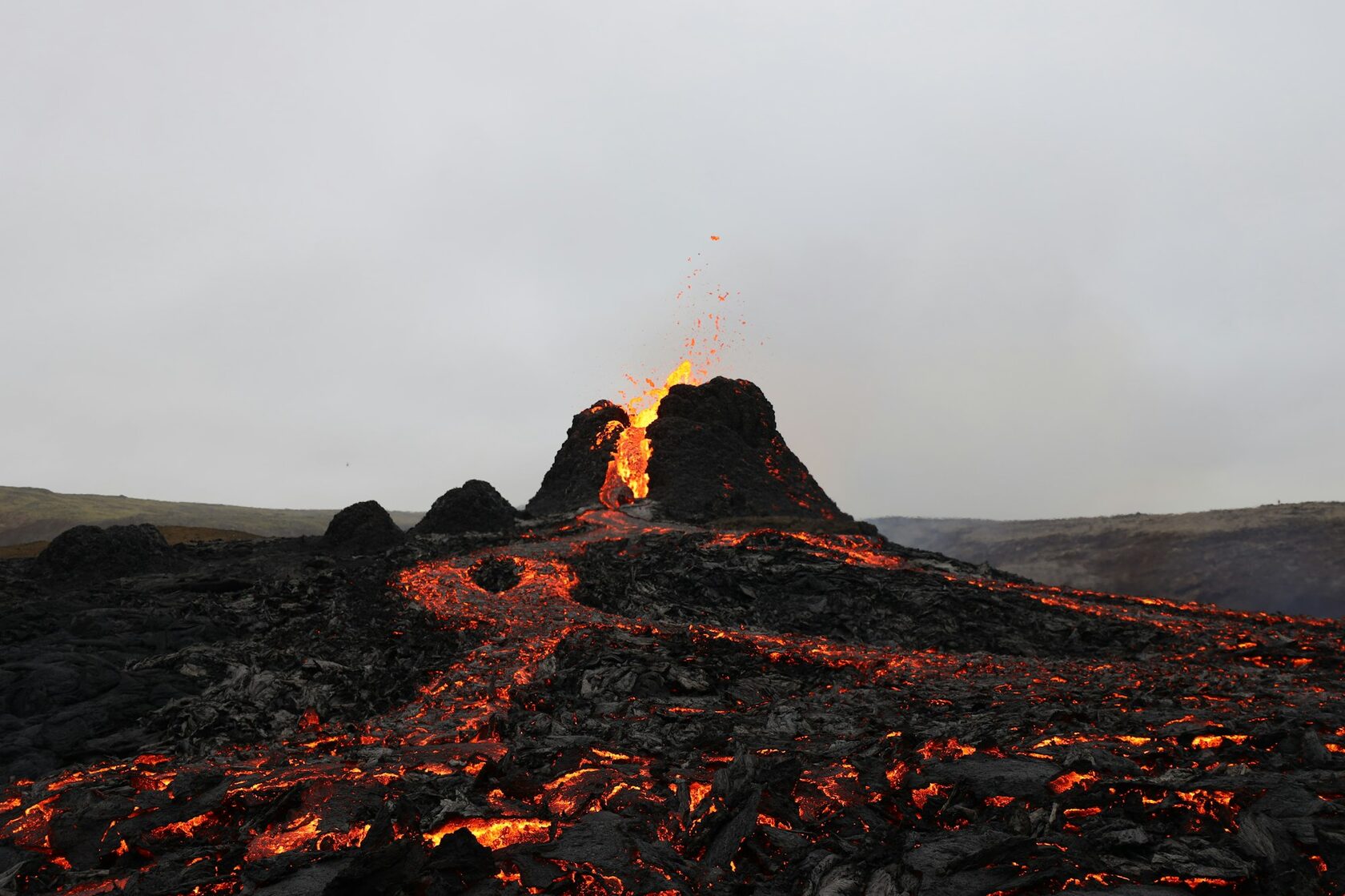 Dramatic volcanic peak with lava flows and rugged terrain