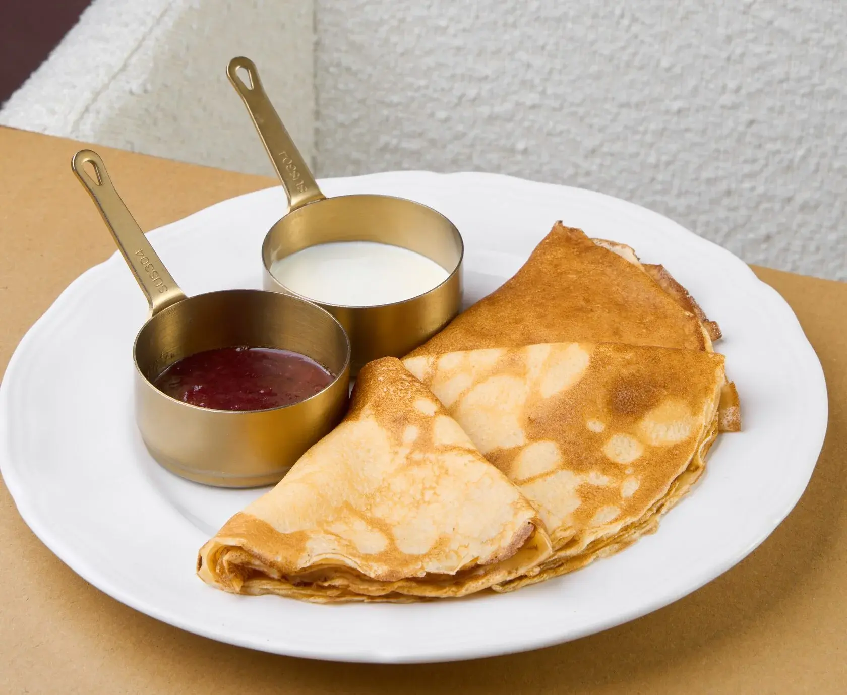 crepes with strawberry jam and sour cream